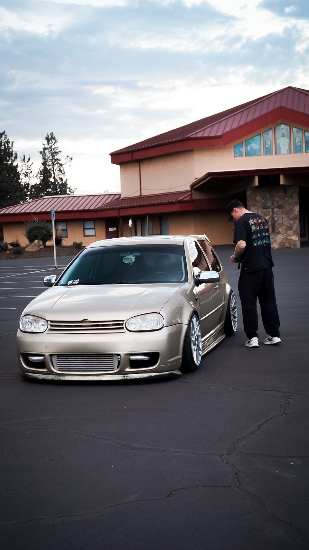 Tyas beside his Volkswagen GTI